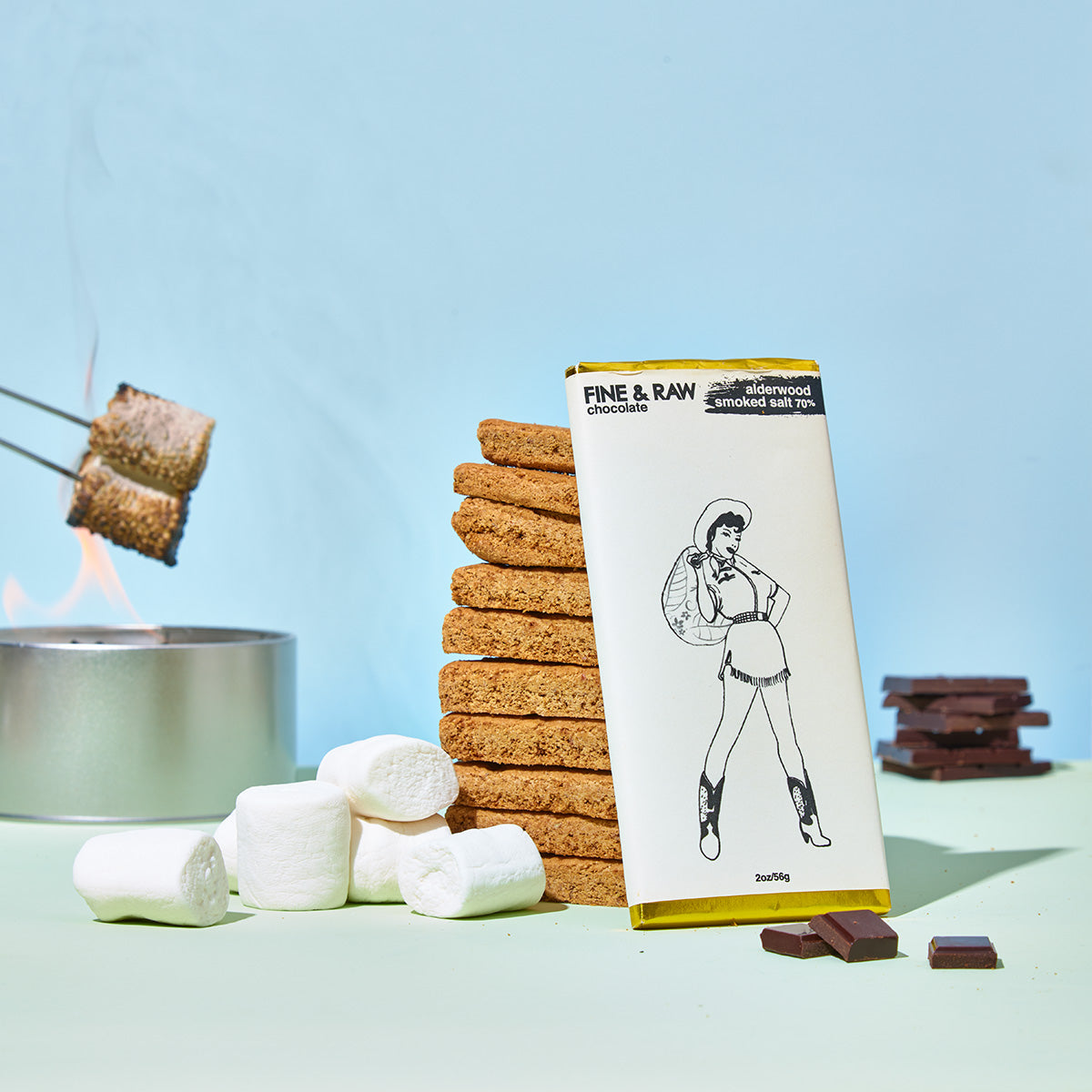 Fine & Raw alderwood smoked salt chocolate with stacked graham crackers and marshmallows ready for toasting.