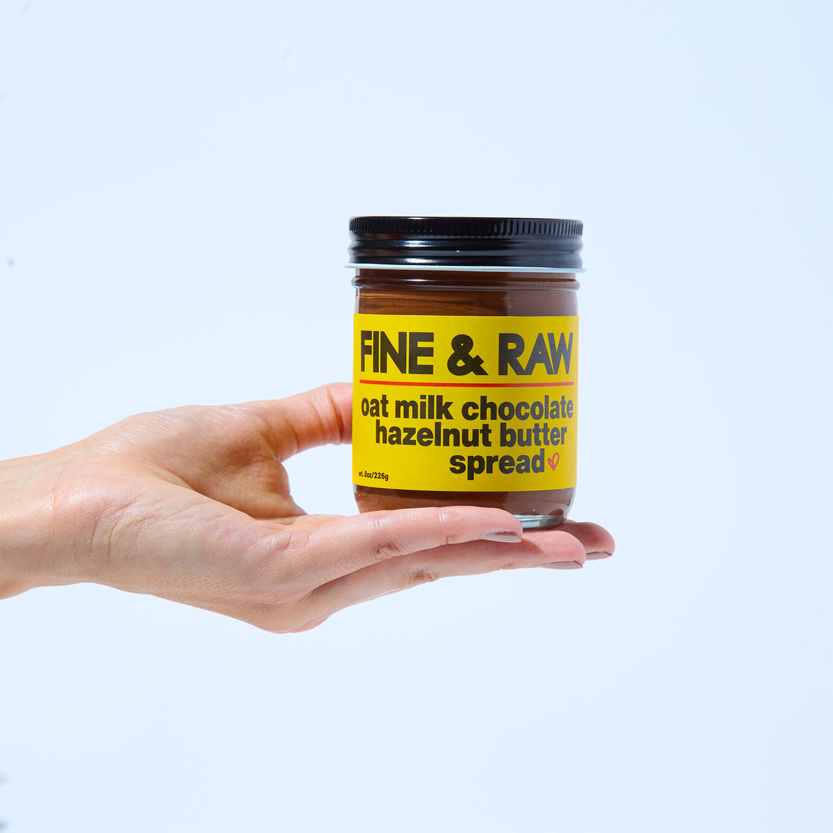 Jar of Oat Milk organic bean to bar chocolate Hazelnut Butter Spread by FINE & RAW organic bean to bar chocolate, styled product photo