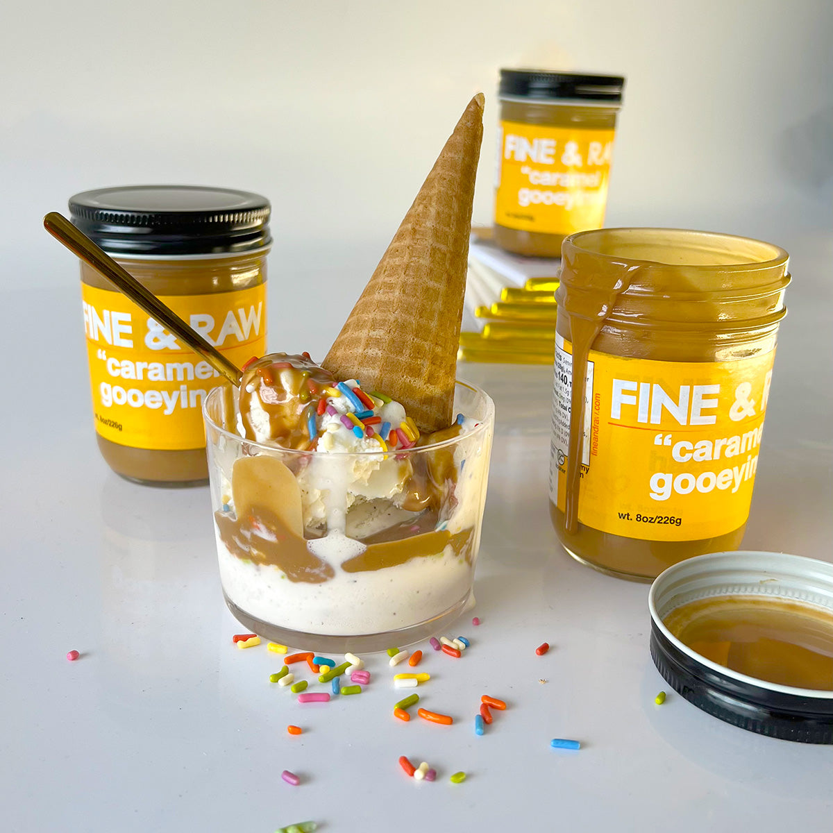 Caramel Gooeyiness Spreads and a cup of ice cream with the caramel, ice cream cone, and sprinkles on top