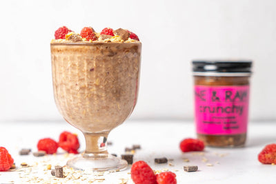 overnight raspberry oats with crunchy chocolate hazelnut butter spread in the background