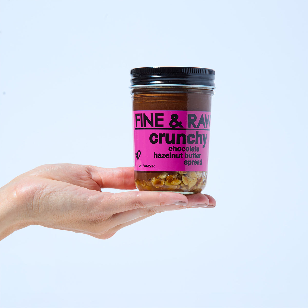 Jar of CRUNCHY organic bean to bar chocolate Hazelnut Butter Spread by FINE & RAW organic bean to bar chocolate, styled product photo