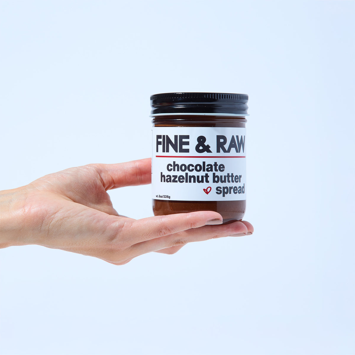Jar of organic bean to bar chocolate Hazelnut Butter Spread by FINE & RAW organic bean to bar chocolate, styled product photo