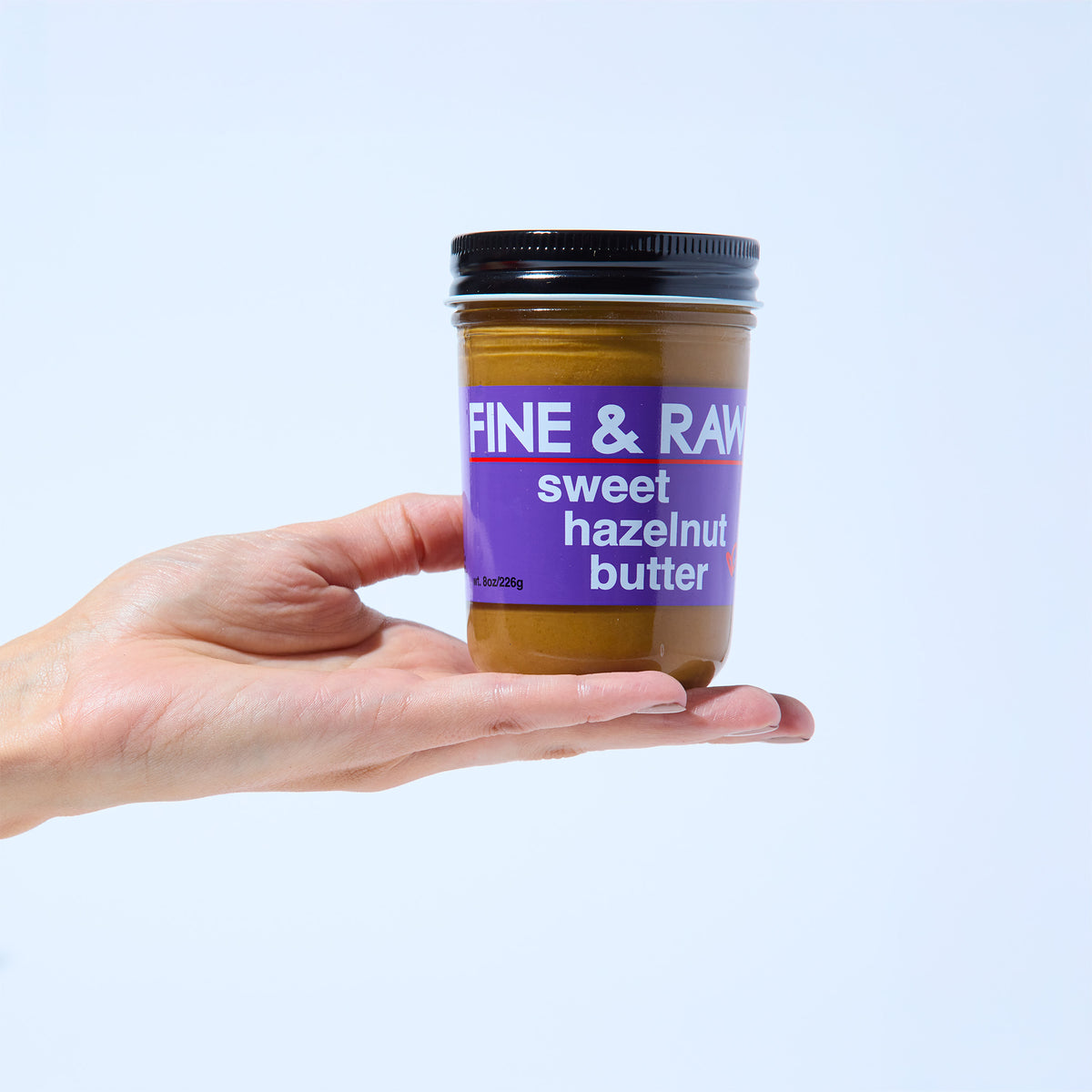 Jar of Sweet Hazelnut Butter Spread by FINE & RAW organic bean to bar chocolate, styled product photo