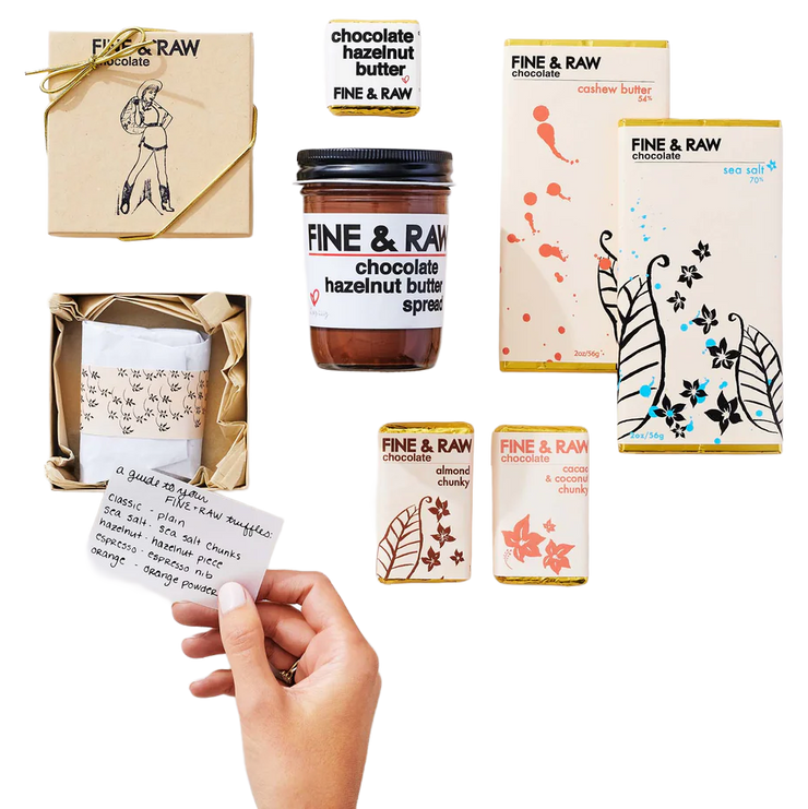 Collection of Fine & Raw chocolate products including jars and boxes on a white background.