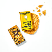 Overhead shot of waffle cone chunky packaging, the opened chocolate bar, and waffle cone pieces