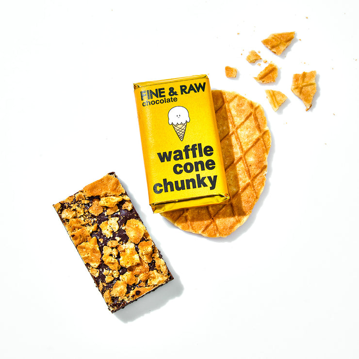 Overhead shot of waffle cone chunky packaging, the opened chocolate bar, and waffle cone pieces