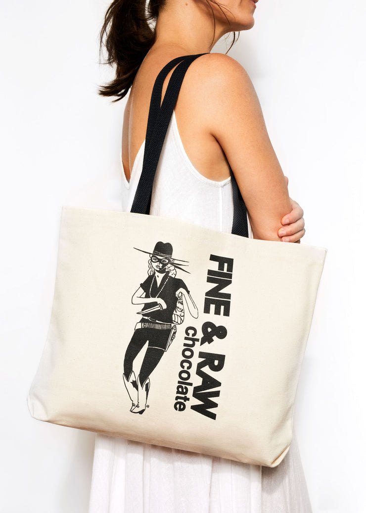 Person wearing a FINE & RAW tote bag